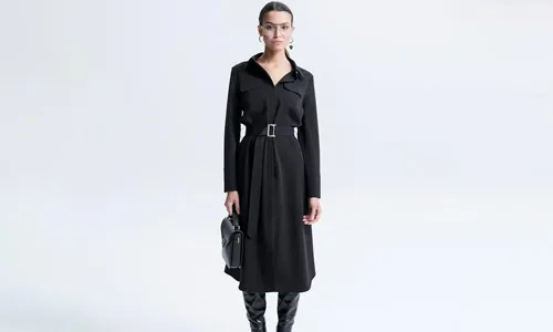 Women-in-full-black-dress,-handbag-and-boots