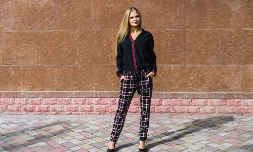 Blonde women wearing black t shirt and checked pants