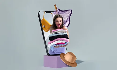 Women holding a pile of clothes in hand and hat on the floor