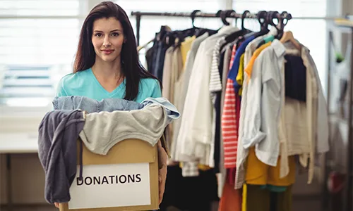 Women holding donation box of clothes