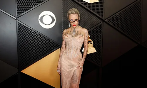 Women in light pink dress with body tattoo