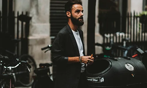 man in black suit and white sneakers