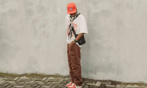 man in orange hat and brown loose pants