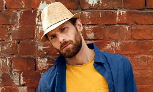 man wearing bucket hats and sunflower in hand