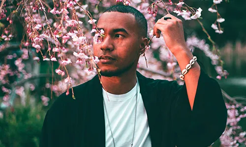 Man Standing Under A Flowering Tree