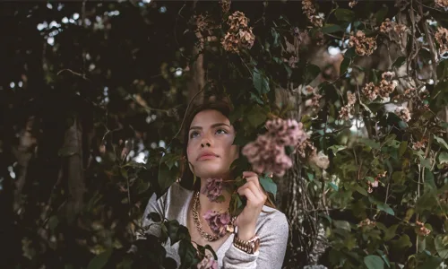 Woman wearing bold necklace and watch