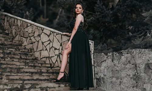 Girl in black dress standing in stairs