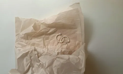Pearl hoop earring in paper sheet