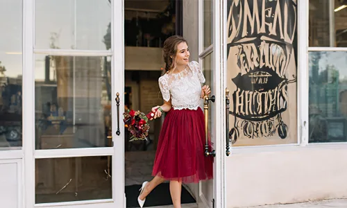 Girl in white lace top red skirt