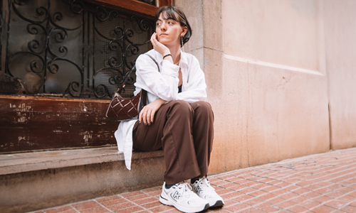 woman-wearing-brown-handbag-and-white-sneakers