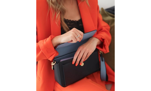 Woman-in-orange-suit-and-blue-handbag