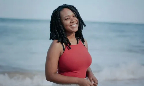 Woman wearing fitted red tank top