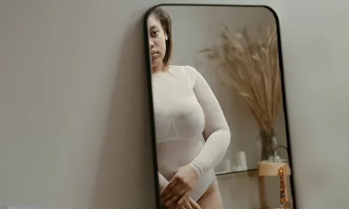 Woman standing in front of mirror