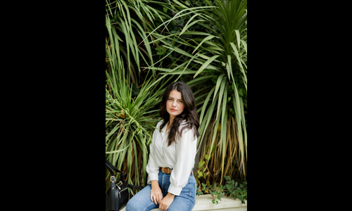 Woman wearing white shirt and brown belt